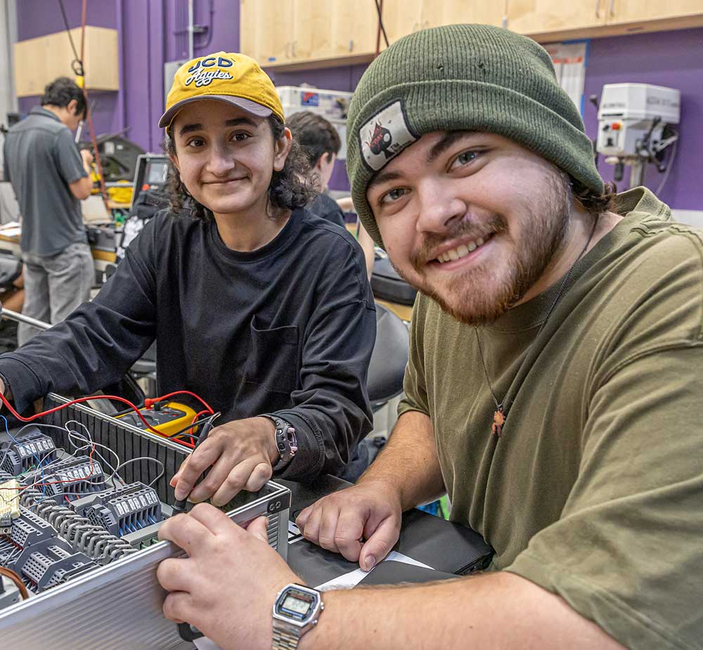 Students working on mechatronics equipment