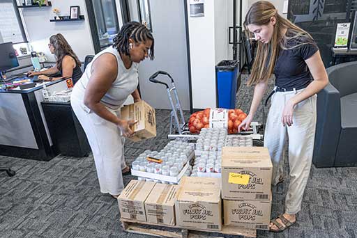 Employees unloading and organizing food donations