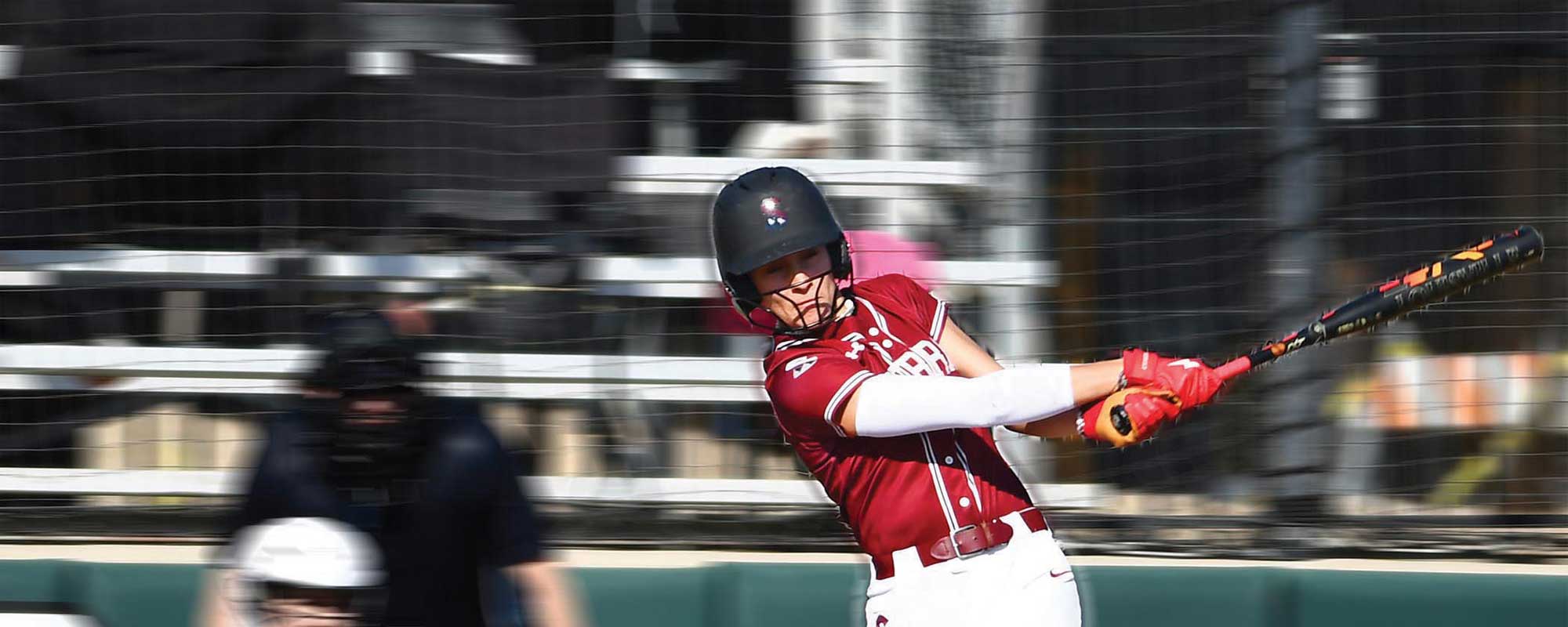 Softball player swing bat