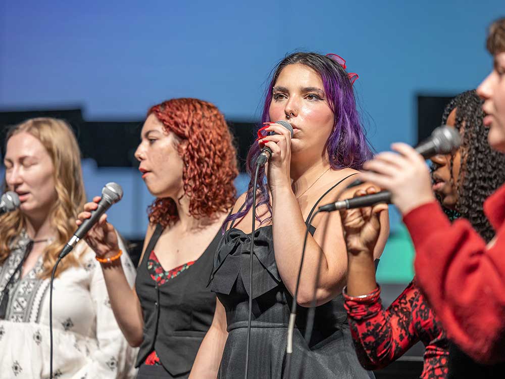 Students singing on stage at Sierra College