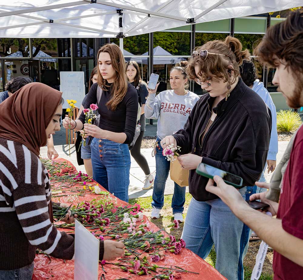 Students create their own flower bouquets on the quad
