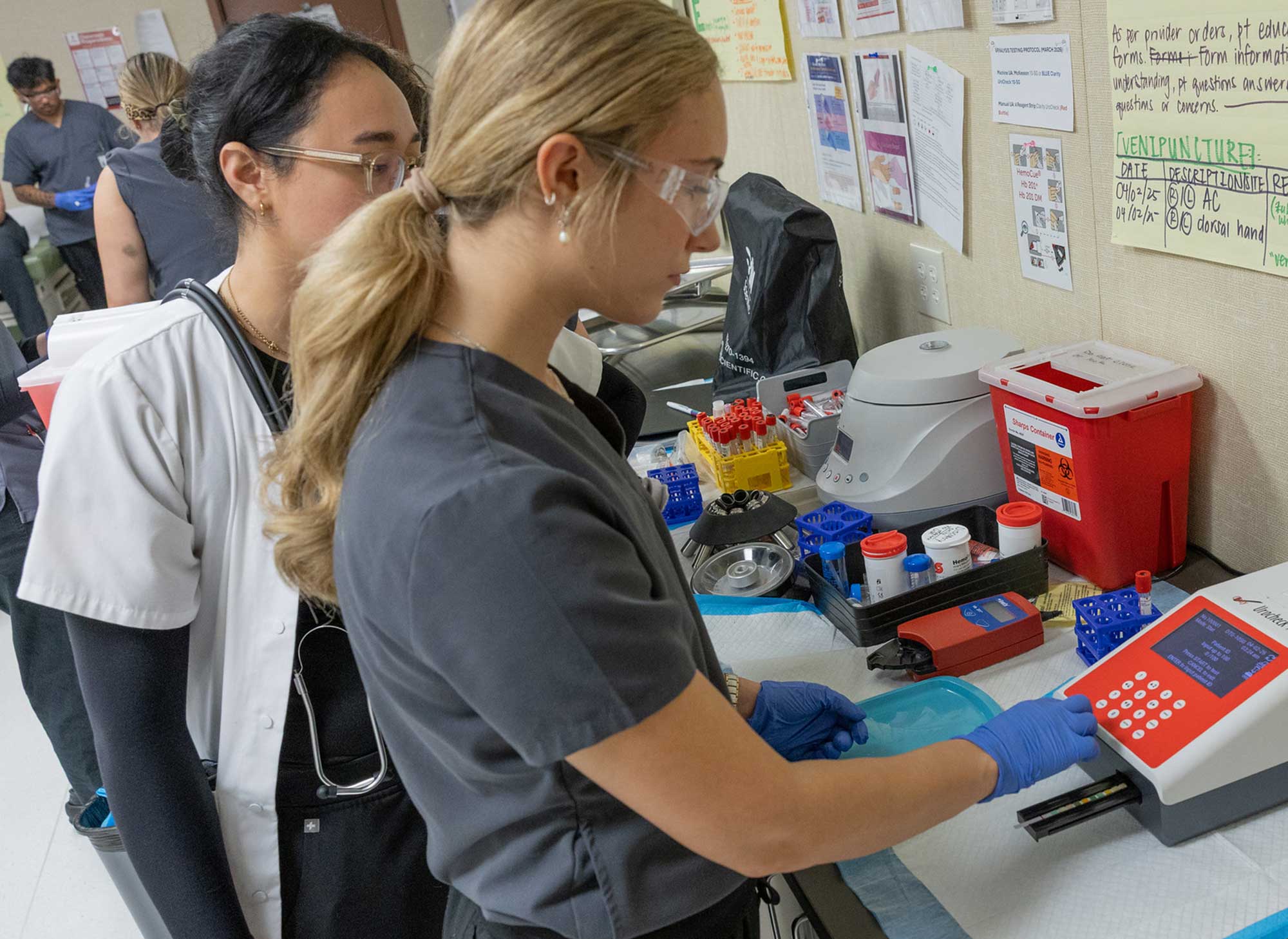 Medical Assistant students practicing tasks on simulated baby.