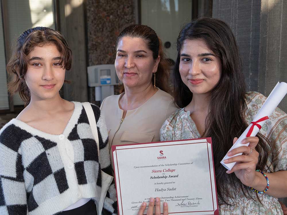 Scholarship award Recipient proudly shows off certificate