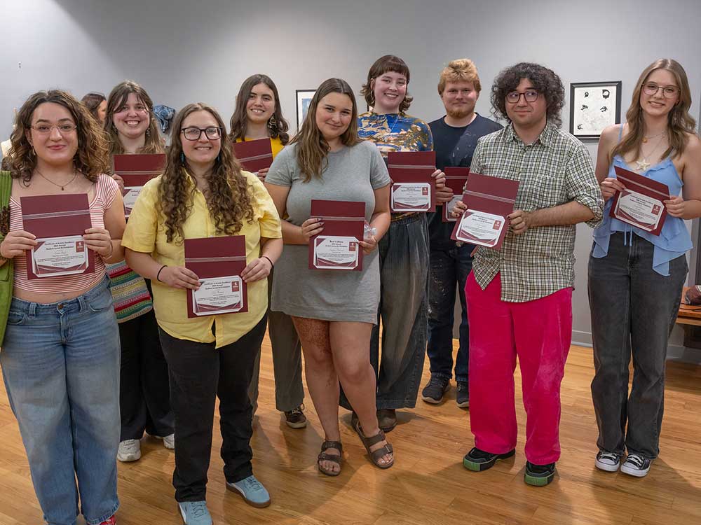 Winners of the Hallberg awards hold up their certificates