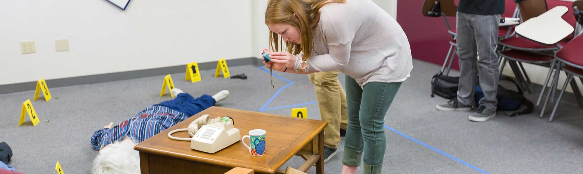 Student takes pictures of mock crime scene
