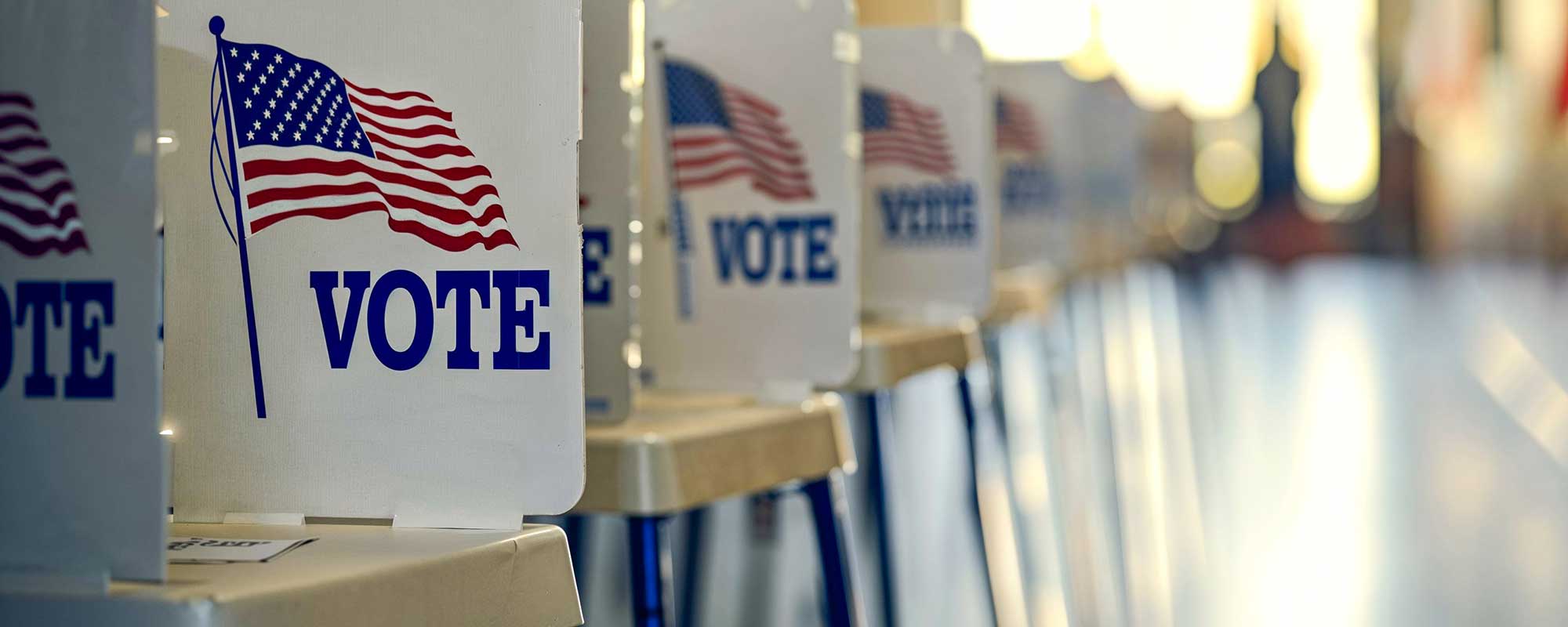 Line of voting privacy booths at an empty polling station, USA Election Day
